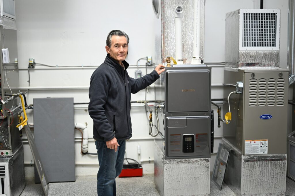 fuse club instructor standing next to hvac equipment