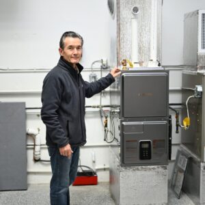 fuse club instructor standing next to hvac equipment